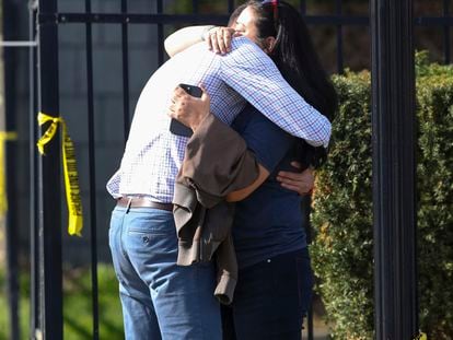 Two people embrace outside of a building where a shooting took place in Louisville, Kentucky, on April 10, 2023.