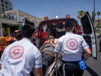 Israeli paramedics evacuate an injured man at the site of a Palestinian car-ramming attack at a bus stop in Tel Aviv, Israel, Tuesday, July 4, 2023.
