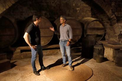 Miquel Palau talks with Ramón Roqueta in the basement of the Roqueta farmhouse, where wine has been made for 800 years in the heart of the Bages region. 