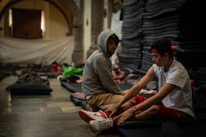 Jason Oliveros and Wilber Giovanni hail from Venezuela. They rest on mats in the Church of La Soledad.