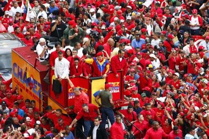 Supporters surround a truck carrying Venezuelan President Hugo Ch&aacute;vez as he makes his way to file his candidacy.