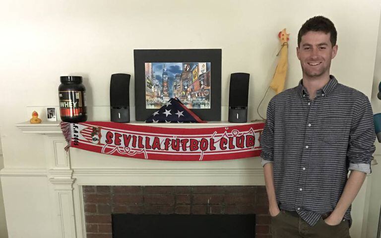 Harvard student Chris Ulian at his digs, with Sevilla FC scarf.