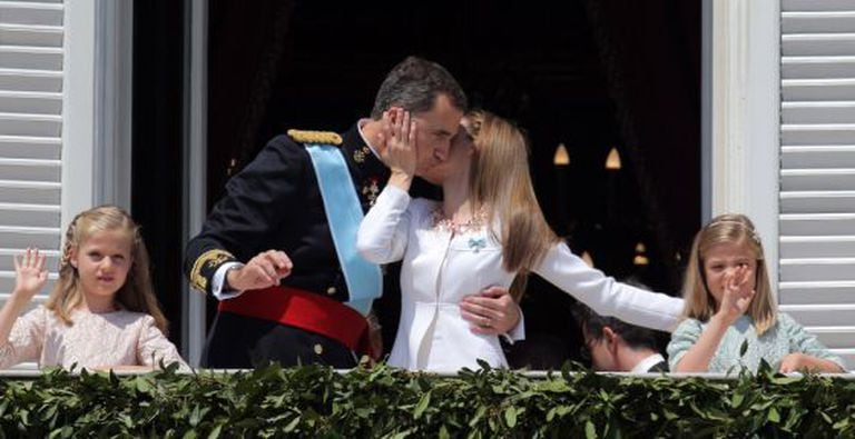 The new king and queen of Spain with their two daughters on the balcony of the Royal Palace.
