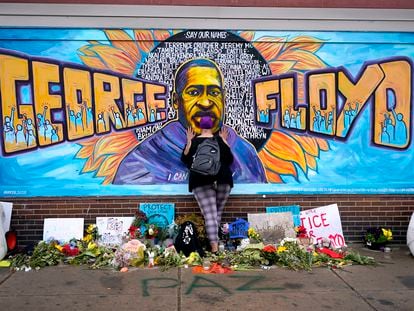 A woman pays respect to George Floyd at a mural at George Floyd Square in Minneapolis, on April 23, 2021.