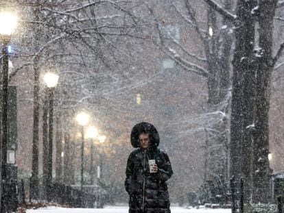 A pedestrian stands as the snow falls during a Nor'easter winter storm in New York City, U.S., February 13, 2024.