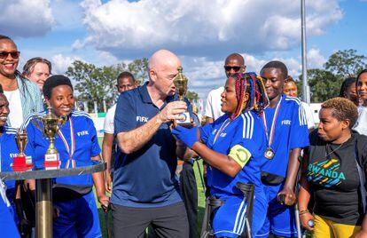 FIFA president Gianni Infantino presents a trophy to the members of the Nyarugenge women's Amputee Football team after their win over Musanze women's amputee football team, after the launch of the women's Amputee Football championship in Rwanda, at the Pele Stadium, in Kigali, Rwanda March 16, 2023.