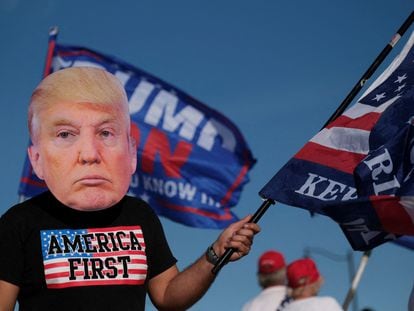 A supporter of former president Donald Trump attends a gathering outside his Mar-a-Lago resort in Palm Beach, Florida, on March 21, 2023.