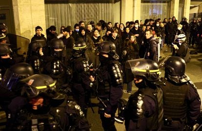 Protesters are surrounded by riot police on the day the National Assembly debates and votes on two motions of no-confidence against the French government.