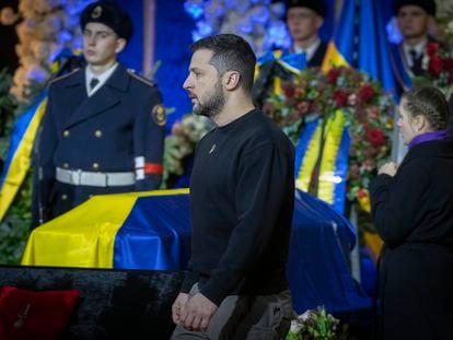 Ukrainian President Volodymyr Zelenskyy pays his respects to victims of a deadly helicopter crash during a farewell ceremony in Kyiv, Ukraine, Saturday, Jan. 21, 2023.