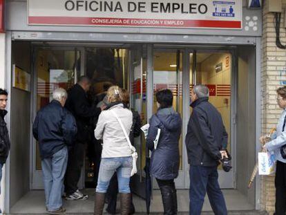 People wait in line at an unemployment office in Madrid's Santa Eugenia district.