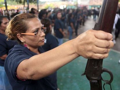 A woman holds a shotgun during the presentation of armed vigilante group - Citizens Self-Protection Police - in Acapulco, Guerrero state. 