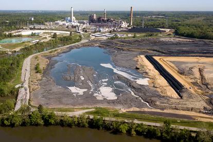 The Richmond city skyline can be seen on the horizon behind the coal ash ponds along the James River near Dominion Energy's Chesterfield Power Station in Chester, Va