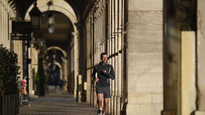 A man jogs in Paris, France, where members of the public can go out onto the street for an hour of physical activity a day under lockdown rules.