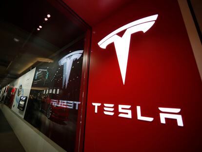 A sign bearing the Tesla company logo is displayed outside a Tesla store in Cherry Creek Mall in Denver, Feb. 9, 2019.
