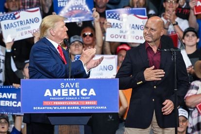 Former president Donald Trump applauds Pennsylvania Republican gubernatorial candidate Doug Mastriano at a rally in Wilkes-Barre on September 3.