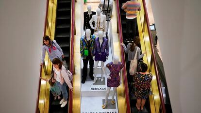 Shoppers move past displays of designer clothes at the Neiman Marcus department store in NorthPark shopping center in Dallas, on March 30, 2023.