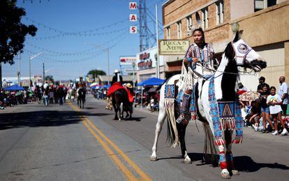 Raquel Sam, a member of the Navajo Nation, rides a horse in a downtown parade at the 100th Gallup Inter-Tribal Indian Ceremonial on August 13, 2022