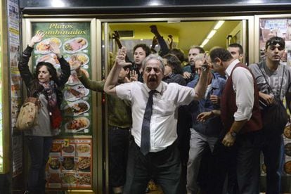 Barman Alberto Casillas faces up to police outside his restaurant at Tuesday's demonstrations.