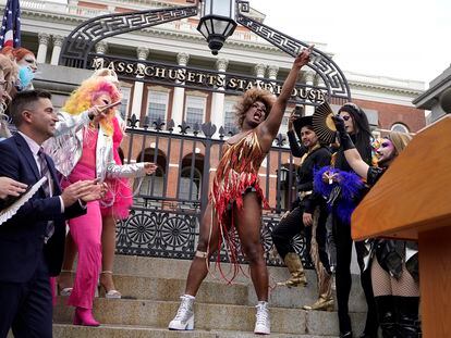 Drag performer Neon Calypso, center, sings and dances to Tina Turner's version of the song "Proud Mary," during a Pride Month Celebration, Wednesday, June 7, 2023, in front of the Statehouse, in Boston.