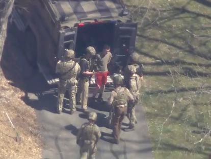 Jack Teixeira, in shorts and a T-shirt, is arrested at his home by the FBI on Thursday, April 13, in Dighton, Massachusetts.