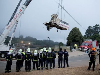 A wagon of a crashed train that killed at least 77 people is lifted at Angrois near Santiago de Compostela, Spain.