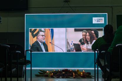 An offering is placed in a room in the University of El Salvador, where the hearing is being watched. 