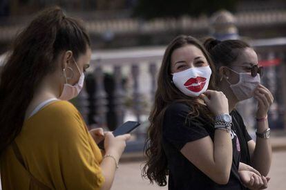 Passers-by wearing masks in Seville on Friday.