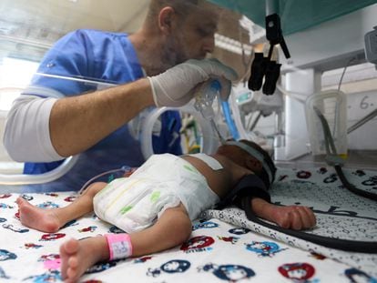 A health worker with a premature Palestinian baby lying in an incubator in the maternity ward of Al Shifa Hospital on October 22.