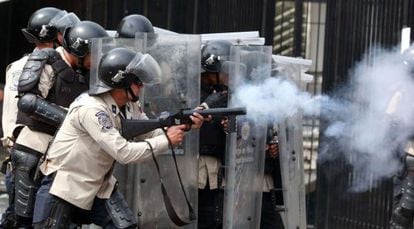Anti-riot police battle with protestors in Caracas on Tuesday.