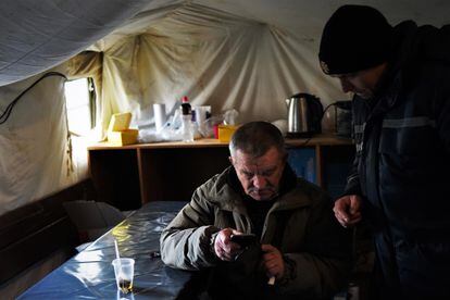 A man drinks tea and connects to the internet at a shelter in Saltivka, which is one of the more than 4,200 points that have been set up across the country.