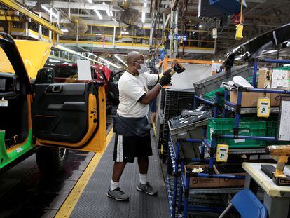 A Ford Motor assembly worker works on a 2021 Bronco SUV  at Michigan Assembly Plant in Wayne, Michigan, U.S., June 14, 2021.