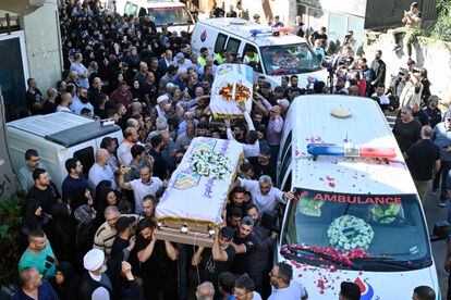 People carry the coffins during the funeral procession for the three children and their grandmother killed in an Israeli airstrike in southern Lebanon