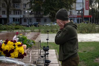 A servicewomen cries as she lays flowers to commemorate those killed in the war, as the city marks one year since Ukraine retook the city of Kherson from occupying Russian forces in Kherson, Ukraine, Saturday, Nov. 11, 2023.