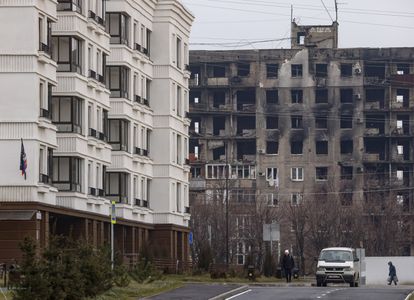 New homes built by the Russian government right across from a damaged building on the other side of Kuprina Street, in December 2022.
 
