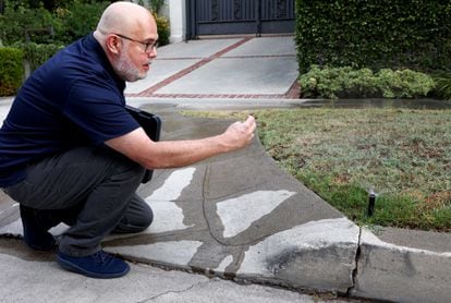 Damon Ayala, one of the water cops deployed in Los Angeles, photographs an irrigation sprinkler. 