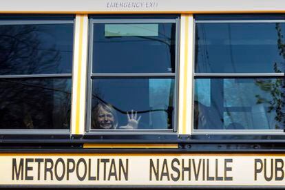 child weeps while on the bus leaving The Covenant School following a mass shooting at the school in Nashville, Tenn