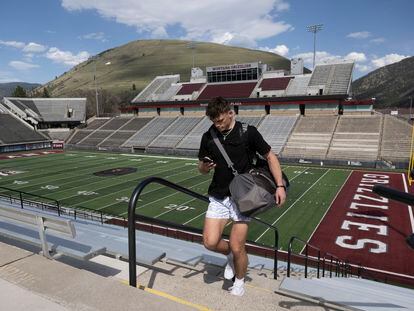 Adam Botkin, a football TikTok influencer, uses his phone after recording a video for a post at Washington-Grizzly Stadium in Missoula, Mont., on Monday, May 1, 2023.