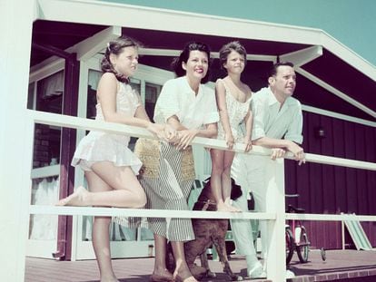 Rita Hayworth and family on a beach house balcony.