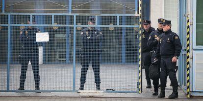Police officers stand at the entrance of the immigrant holding center in Barcelona.