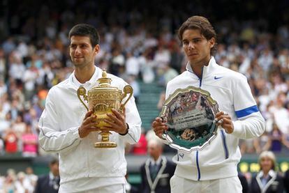 Djokovic and Nadal pose with their respective winner and runner-up's trophies at Wimbledon.