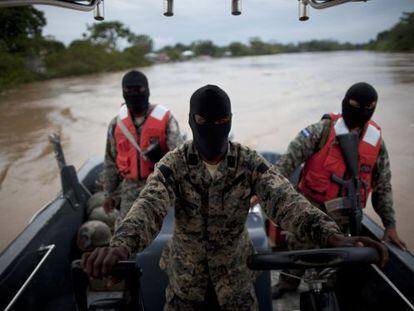 Honduran navy officers patrol the Patuca River near where last week&#039;s shooting incident occurred.