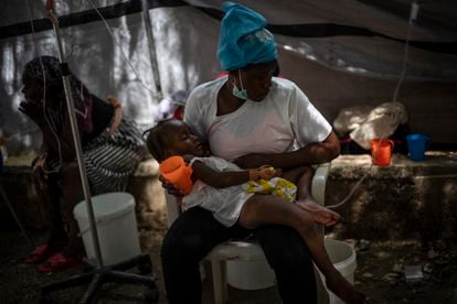 A girl with cholera symptoms is treated at a clinic in Port-au-Prince