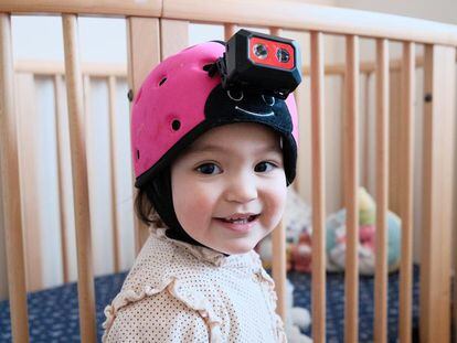 Sam, the Australian boy who participated in the experiment, at 18-months-old. He is pictured wearing a helmet with a camera.