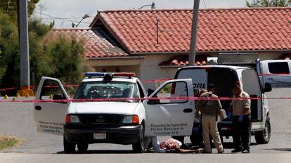 A forensic team examines the crime scene in Guadalupe on Tuesday.