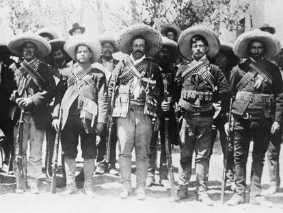Pancho Villa, Mexican bandit and revolutionary leader, lined up with some of his followers.