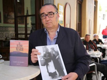 Joaquín García de Romeu holds a photo of Cándida next to his book, ‘The Last Black Woman.’
