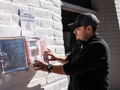 Channing Velázquez, a recovering fentanyl addict and worker with the organization 'Circulos de Paz,' stands next to an emergency naxolone kit, which works to prevent fentanyl overdoses, in Nogales, Arizona.
