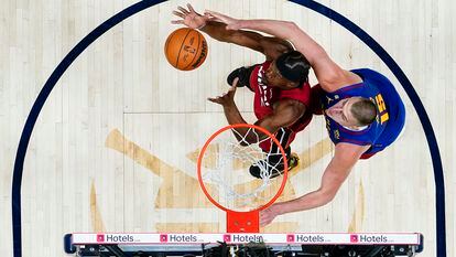Jimmy Butler grabs a rebound off Nikola Jokic in Game 1 of the NBA Finals.