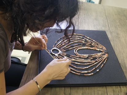 Hala Alarashi puts the finishing touches on the necklace before displaying it at the new museum in Petra, Jordan.