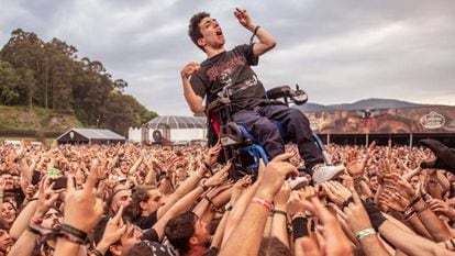 A man in a wheelchair is raised up by the crowd at Resurrection Fest.